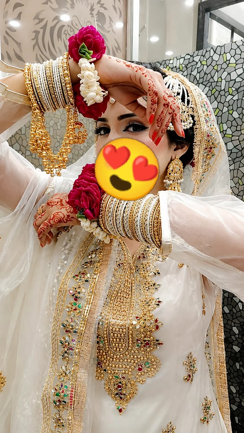Bride in white and gold dress with bridal makeup in Kasur
