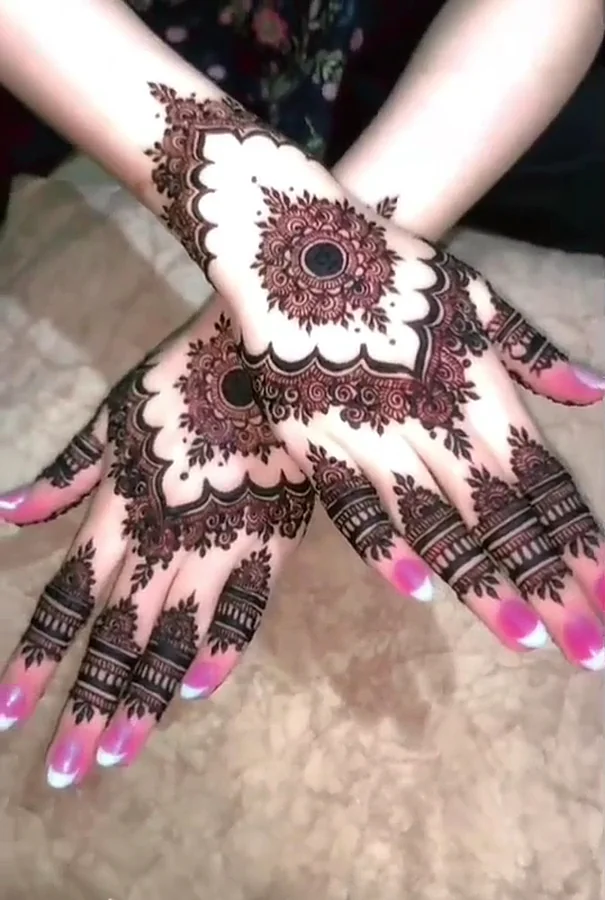 White-style mehndi on crossed hands at our Kasur salon